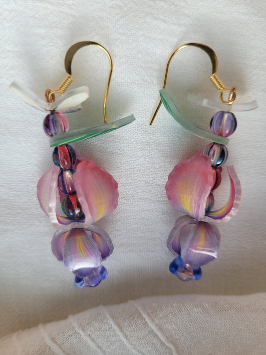 Nature-inspired handmade iris and butterfly earrings with delicate gold-tone hooks on a white background.
