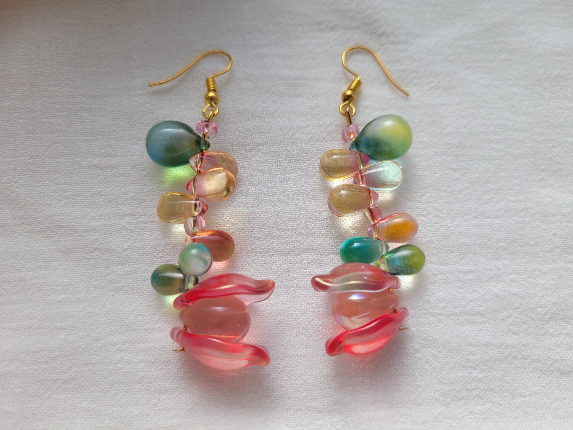 Colorful glass beads earrings on a light gray background