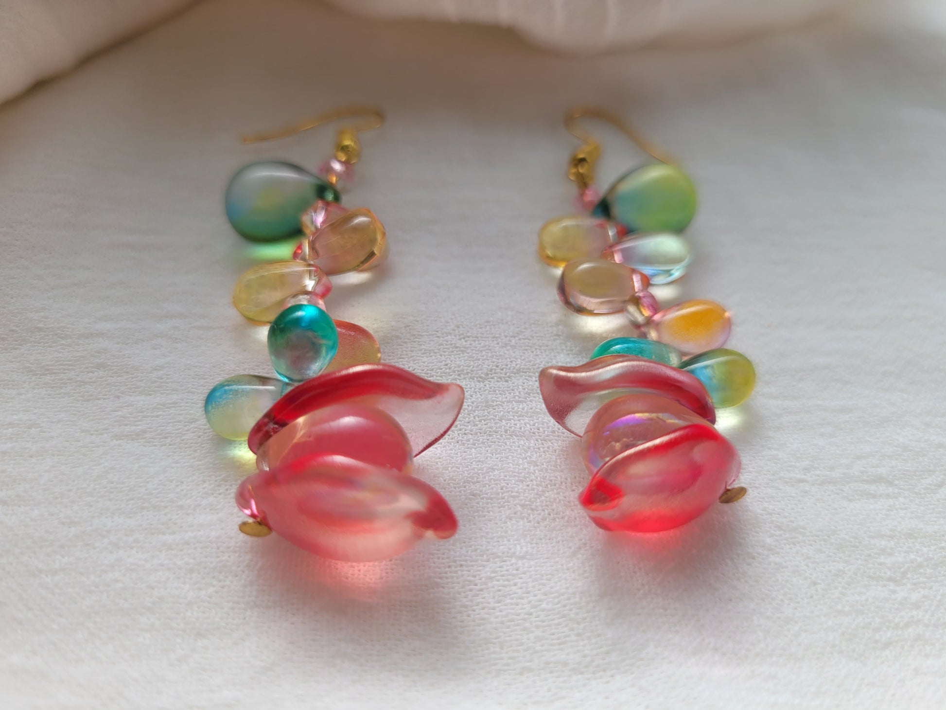 Colorful glass beads earrings on a white background