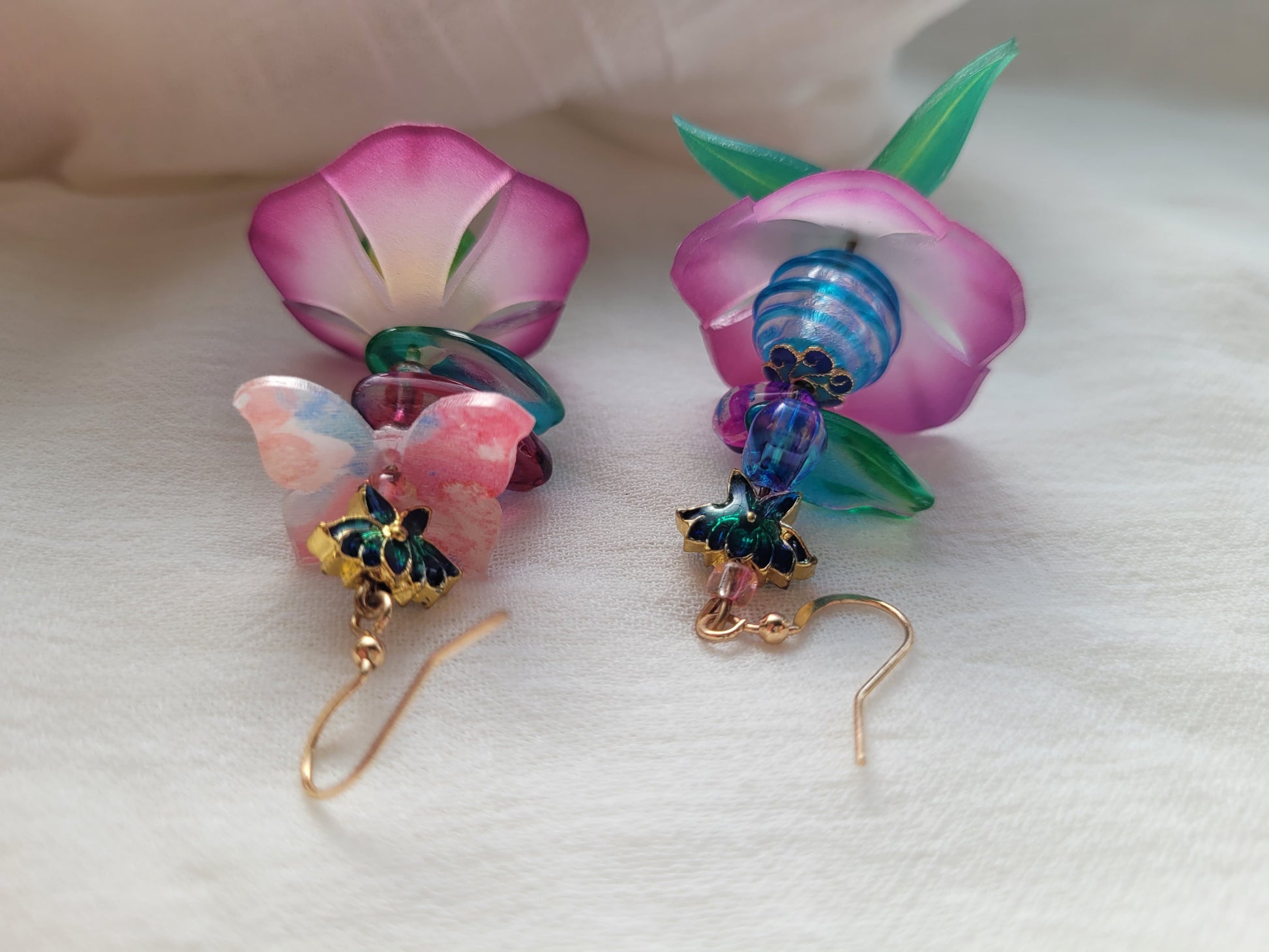 Pair of floral-themed earrings with colorful beads on a white background