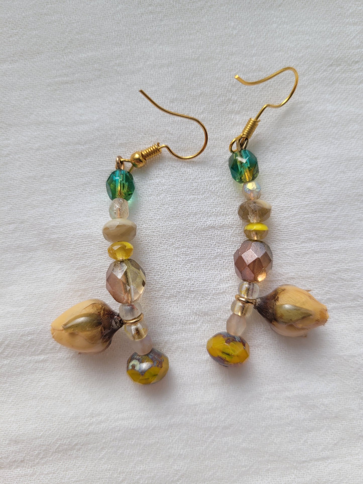 Pair of beaded earrings with natural yellow rose buds