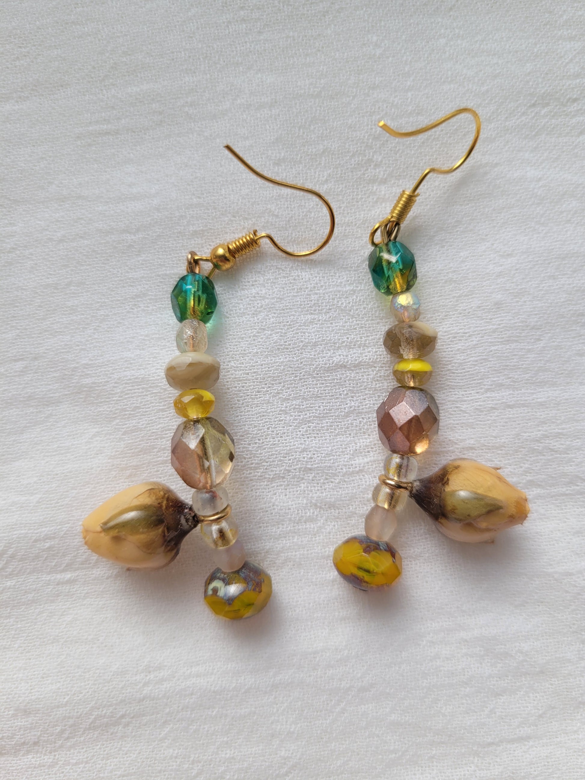 Pair of beaded earrings with natural yellow rose buds