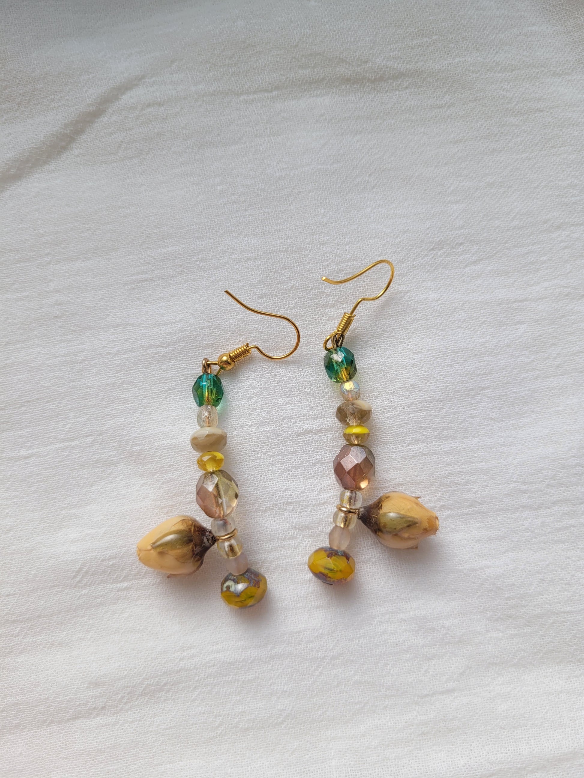Pair of beaded earrings with natural yellow rose buds
