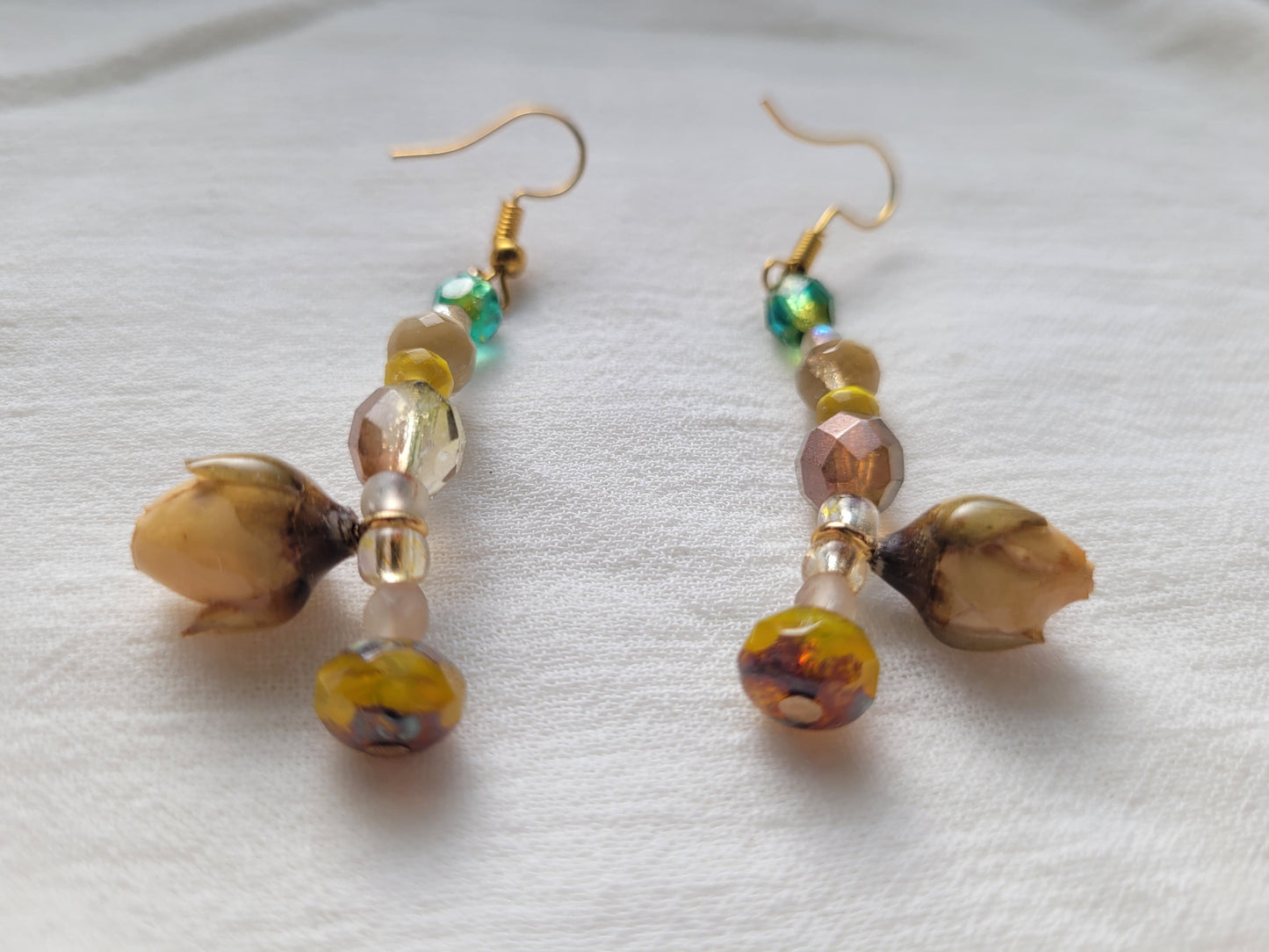 Pair of beaded earrings with natural yellow rose buds