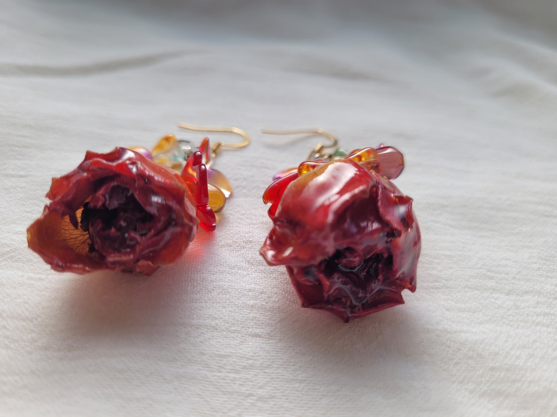 Rose-shaped earrings on a white background